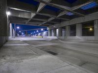 an empty parking garage with no people in it at night time time with only one stop sign