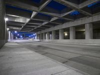an empty parking garage with no people in it at night time time with only one stop sign
