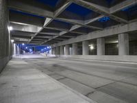 an empty parking garage with no people in it at night time time with only one stop sign