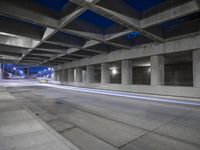 an empty parking garage with no people in it at night time time with only one stop sign
