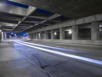an empty parking garage with no people in it at night time time with only one stop sign