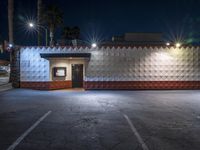 this empty business is located in a parking lot outside at night with no one around