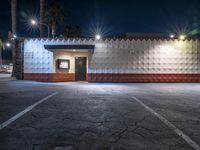 this empty business is located in a parking lot outside at night with no one around