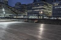 a view of new york city skyline at night from pier on the hudson river side