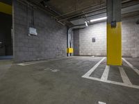 a parking garage with an exit door in it and a parking lot floor painted yellow