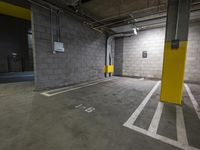 a parking garage with an exit door in it and a parking lot floor painted yellow