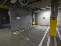 a parking garage with an exit door in it and a parking lot floor painted yellow