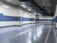 two large parking spaces with parking meters attached to them in a building at night,