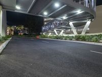 a view of a road and an overpass with traffic passing through it by buildings