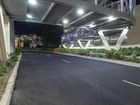 a view of a road and an overpass with traffic passing through it by buildings