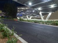 a view of a road and an overpass with traffic passing through it by buildings