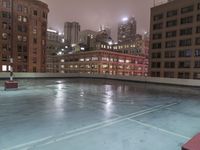 a sky scraper cleaning out ice in an empty pool on the side of a building