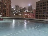 a sky scraper cleaning out ice in an empty pool on the side of a building