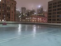 a sky scraper cleaning out ice in an empty pool on the side of a building