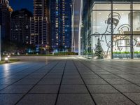 a photo taken of a courtyard area at night with a christmas tree outside a large building