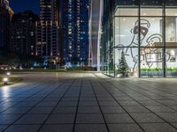 a photo taken of a courtyard area at night with a christmas tree outside a large building