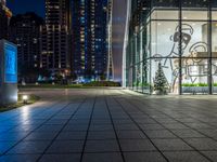 a photo taken of a courtyard area at night with a christmas tree outside a large building