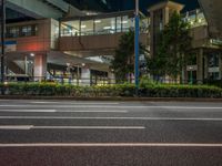 an image of outside of the night time building with the lights turned on and the streets empty