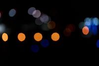 a dark, lit image with a blurry background that shows many multi - colored lights in different shades