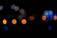 a dark, lit image with a blurry background that shows many multi - colored lights in different shades