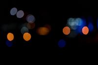 a dark, lit image with a blurry background that shows many multi - colored lights in different shades