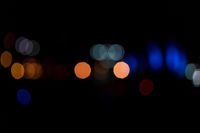 a dark, lit image with a blurry background that shows many multi - colored lights in different shades