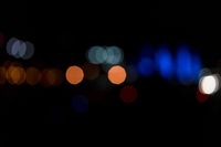 a dark, lit image with a blurry background that shows many multi - colored lights in different shades