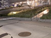 a manhole on the sidewalk next to steps and a city street light on it