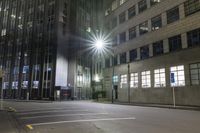 the bright lights are reflecting off of the windows on a building in an urban area