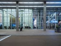 an empty parking lot is pictured at an airport terminal with glass walls on both sides