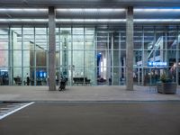 an empty parking lot is pictured at an airport terminal with glass walls on both sides