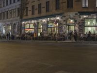 the street has light streaks from cars coming in the window of it and a building that is empty