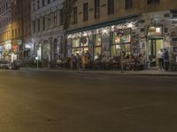the street has light streaks from cars coming in the window of it and a building that is empty