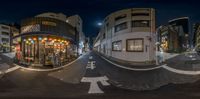 a fisheye photo of a downtown street at night in japan with a traffic sign and arrow pointing up