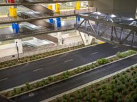 a view of a road and an overpass with traffic passing through it by buildings