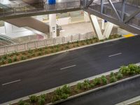 a view of a road and an overpass with traffic passing through it by buildings