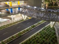 a view of a road and an overpass with traffic passing through it by buildings