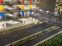 a view of a road and an overpass with traffic passing through it by buildings