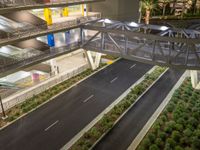 a view of a road and an overpass with traffic passing through it by buildings