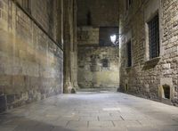 an empty passageway with no people or any doors in it and some stone walls inside