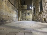 an empty passageway with no people or any doors in it and some stone walls inside