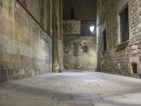 an empty passageway with no people or any doors in it and some stone walls inside