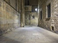 an empty passageway with no people or any doors in it and some stone walls inside