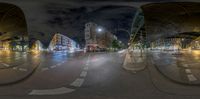 a street view in the middle of some buildings at night, and with two buses in the middle of it