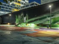 a large green building with stairs leading up to a walkway with painted street lights on it