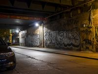 Nighttime Berlin City Street with Graffiti Wall