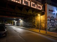 Nighttime Berlin City Street with Graffiti Wall