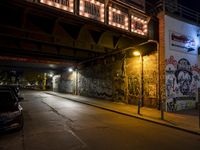 Nighttime Berlin City Street with Graffiti Wall
