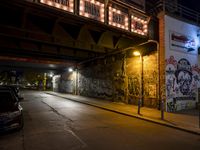 Nighttime Berlin City Street with Graffiti Wall
