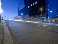 a long exposured photo of the city streets at night, and a car passes by